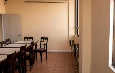 a room with a long table and chairs in it at Hotel Novo in San José