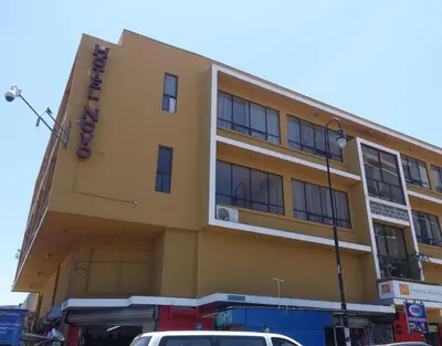 a yellow building with a sign on the side of it at Hotel Novo in San José
