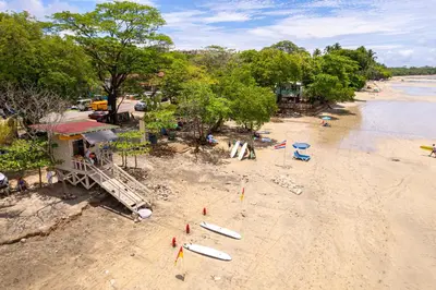 an overhead view of a beach with surfboards on it at Condo La Perla 163, Ocean View 3 Bedroom Penthouse in Tamarindo