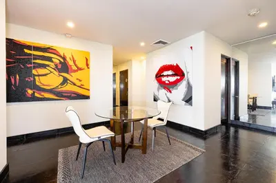a dining room with a glass table and two chairs at Condo La Perla 163, Ocean View 3 Bedroom Penthouse in Tamarindo