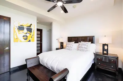 a bedroom with a bed and a ceiling fan at Condo La Perla 163, Ocean View 3 Bedroom Penthouse in Tamarindo