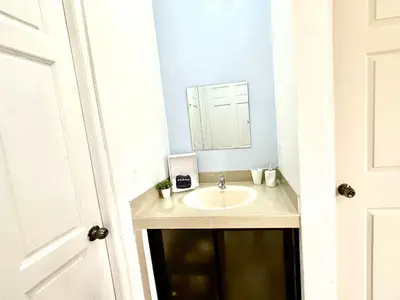 a bathroom with a sink and a mirror at Oasis Arenal Villa Downtown Arenal Volcano View in Fortuna