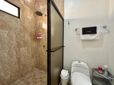 a bathroom with a shower stall and a toilet at Oasis Arenal Villa Downtown Arenal Volcano View in Fortuna