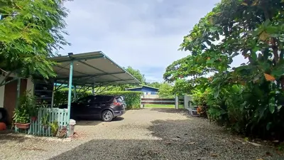 a car parked under a canopy in a driveway at Apartamento con Terraza y Vista al Jardín in Uvita