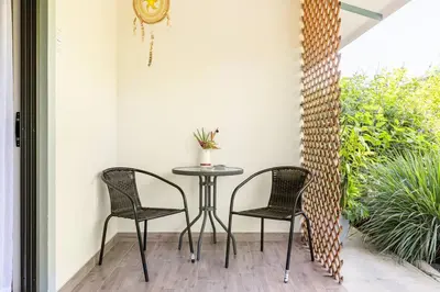 a table and two chairs on a patio at Beautiful studio-apartment near the beach in Uvita