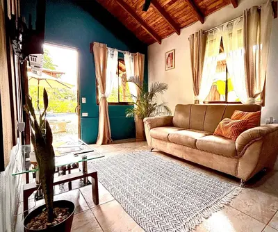 a living room with a couch and a table at Cabañas Litos #2 in Fortuna