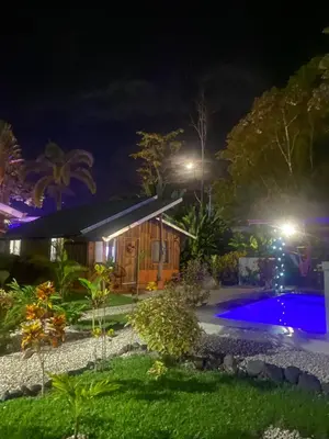 a house with a swimming pool at night at Cabañas Litos #2 in Fortuna