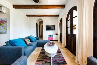 a living room with blue couches and a white table at Plaza Carlota 2 At Las Catalinas in Playa Danta