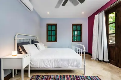 a bedroom with a white bed and a window at Plaza Carlota 2 At Las Catalinas in Playa Danta