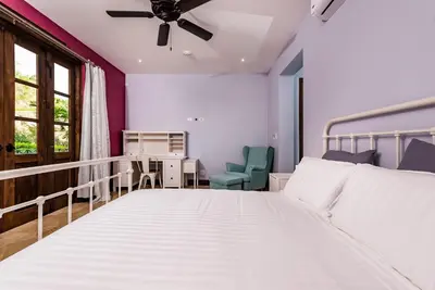 a bedroom with a bed and a desk and a window at Plaza Carlota 2 At Las Catalinas in Playa Danta