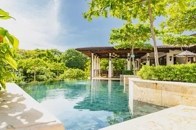 an infinity pool in the backyard of a house at Plaza Carlota 2 At Las Catalinas in Playa Danta