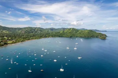 an island with boats in a large body of water at Modern Split-Level 2-Bedroom Condo with Pools, Terrace & Easy Beach Access in Coco