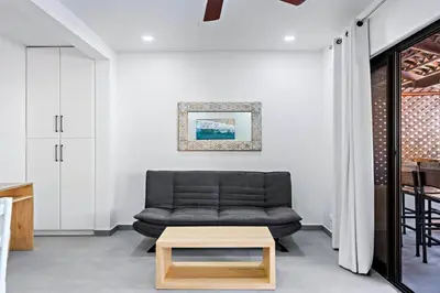 a living room with a couch and a coffee table at Modern Split-Level 2-Bedroom Condo with Pools, Terrace & Easy Beach Access in Coco
