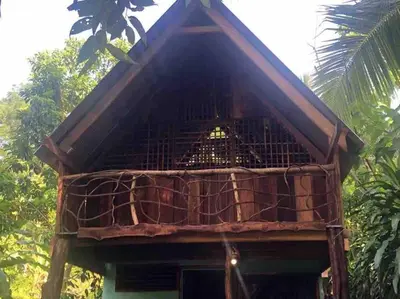 a bird cage on top of a house at Cabina Playa Cedros in Cóbano