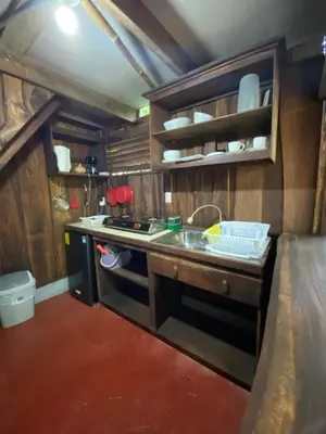 a small kitchen with a stove and a sink at Cabina Playa Cedros in Cóbano
