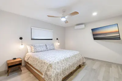 a bedroom with a bed and a ceiling fan at Luxe Tropical Villa with Sparkling Infinity Pool, Panoramic Ocean Views & Community Amenities in Playa Flamingo