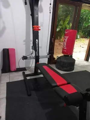 a gym with a red object next to a machine at Arenal Getaway in Fortuna