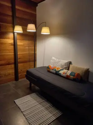 a room with a bed with two lights on it at Arenal Getaway in Fortuna