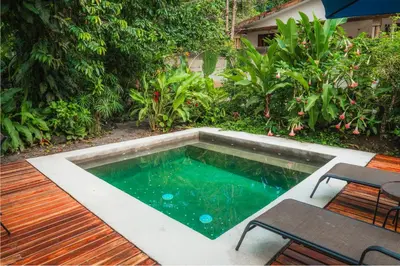 a small pool with a table and chairs on a deck at Arenal Getaway in Fortuna
