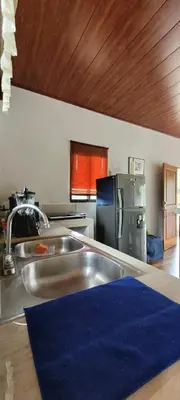 a kitchen with a sink and a refrigerator at Villa Marina, Nosara in Nosara