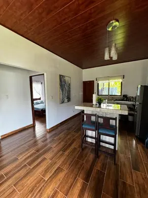 a kitchen with wooden floors and a counter in a room at Villa Marina, Nosara in Nosara