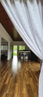 a large room with a white ceiling and wooden floors at Villa Marina, Nosara in Nosara