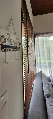 a room with a window with a couch and a welcome sign at Villa Marina, Nosara in Nosara