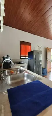 a kitchen with a sink and a refrigerator at Villa Marina, Nosara in Nosara