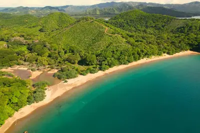 an aerial view of a beach with trees and water at Hotel Hacienda Casa del Viento in Cuajiniquil