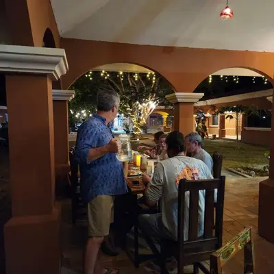 a group of people sitting at a table at a restaurant at Hotel Hacienda Casa del Viento in Cuajiniquil
