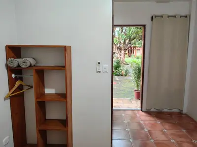 a door leading into a room with a door open at Hotel Hacienda Casa del Viento in Cuajiniquil