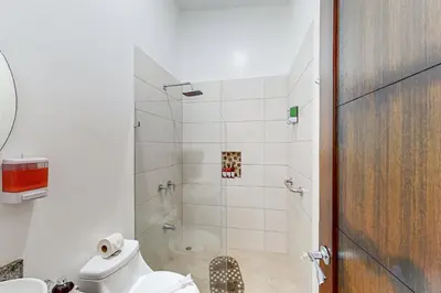 a bathroom with a shower with a toilet and a sink at Casa Eureka in Herradura