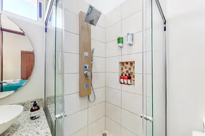 a bathroom with a shower and a sink at Casa Eureka in Herradura