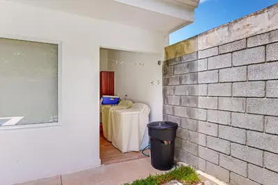 a room with a table and a wall at Casa Eureka in Herradura