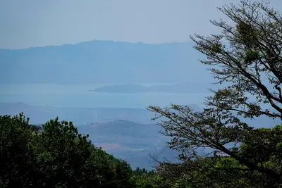 a view of a mountain with trees in the foreground at Cabaña Indira in Monteverde Costa Rica
