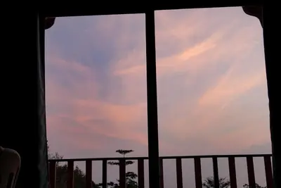 a window view of the sky at sunset at Cabaña Indira in Monteverde Costa Rica
