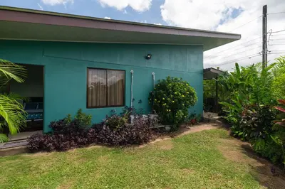 a blue house with a window and plants at Vacation Home Bartenderluisch in Fortuna
