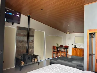 a living room with a couch and a fireplace at Villas Páramo Cloud Forest Hotel in División