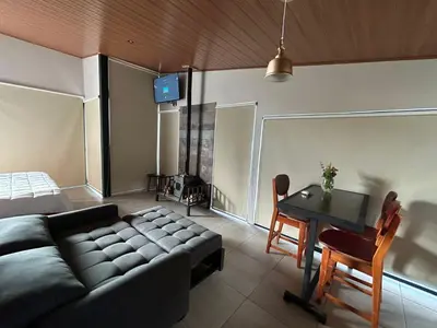 a living room with a couch and a table at Villas Páramo Cloud Forest Hotel in División