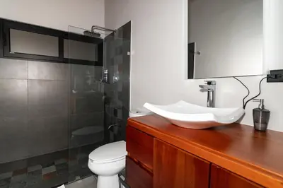 a bathroom with a sink and a toilet at Villas Páramo Cloud Forest Hotel in División