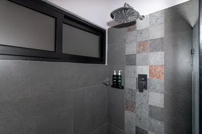 a bathroom with a shower with a glass door at Villas Páramo Cloud Forest Hotel in División