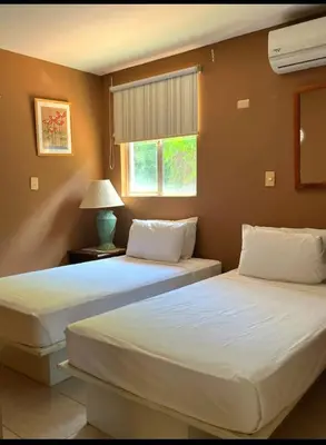 two beds sitting next to each other in a bedroom at VistaMar - La Morada del Ocaso in Playa Hermosa