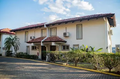 a large white building with a driveway at VistaMar - La Morada del Ocaso in Playa Hermosa