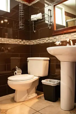 a bathroom with a toilet and a sink at VistaMar - La Morada del Ocaso in Playa Hermosa