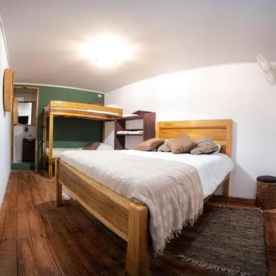 a bedroom with a bed and a bunk bed at Veragua Rainforest in Puerto Limón