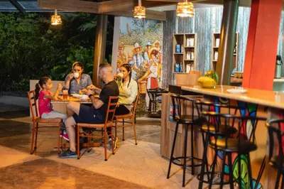 a group of people sitting at a table in a restaurant at Veragua Rainforest in Puerto Limón