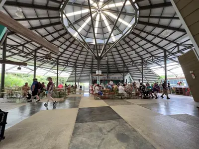 a group of people walking around in a building at Veragua Rainforest in Puerto Limón