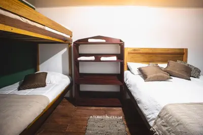 two bunk beds in a room with twothirds gmaxwell at Veragua Rainforest in Puerto Limón