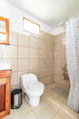 a bathroom with a toilet and a sink at Finca Mango - 40 acre paradise in Roble