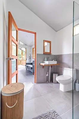 a bathroom with a toilet and a sink at Finca Mango - 40 acre paradise in Roble